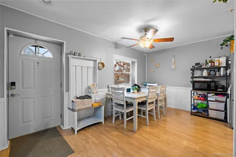 a dining room with furniture a rug and a chandelier