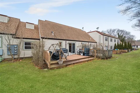 a view of a house with a yard and sitting area