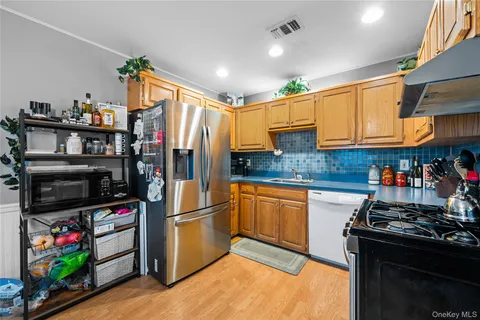 a kitchen with stainless steel appliances granite countertop a refrigerator and a stove top oven