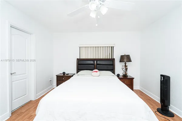 a bedroom with a bed and a night stand