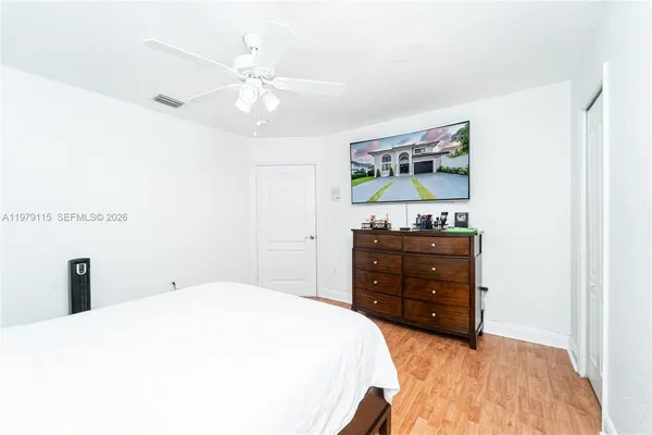 a bedroom with a bed and a dresser