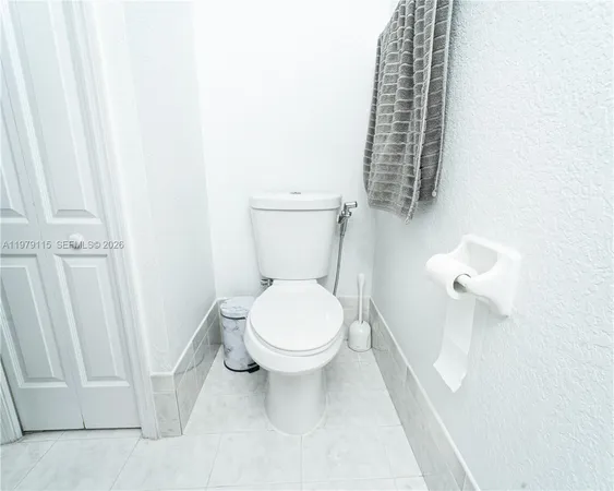 a white toilet sitting next to a shower