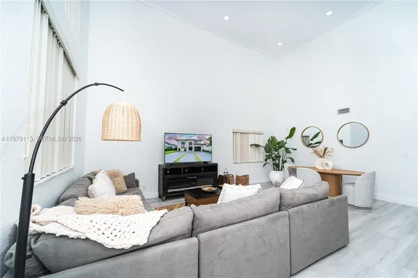 a living room with furniture flowerpot and a potted plant