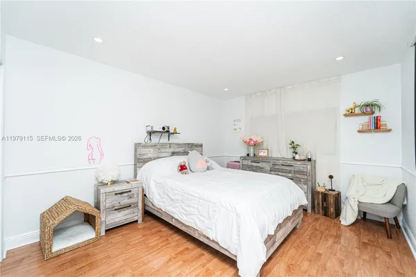 a bedroom with a bed and a dresser