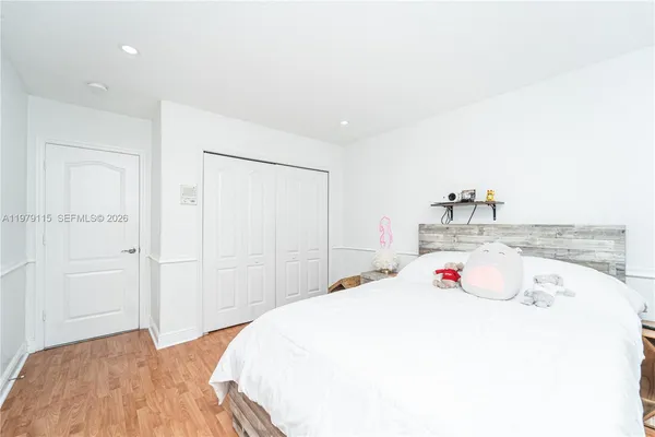 a bedroom with a bed and closet