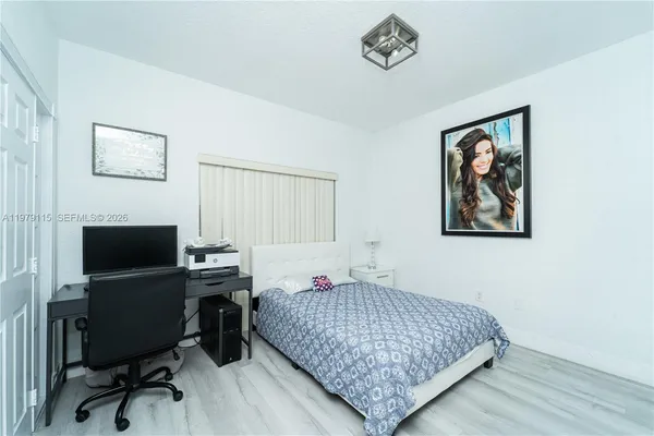 a bedroom with a bed and a workspace