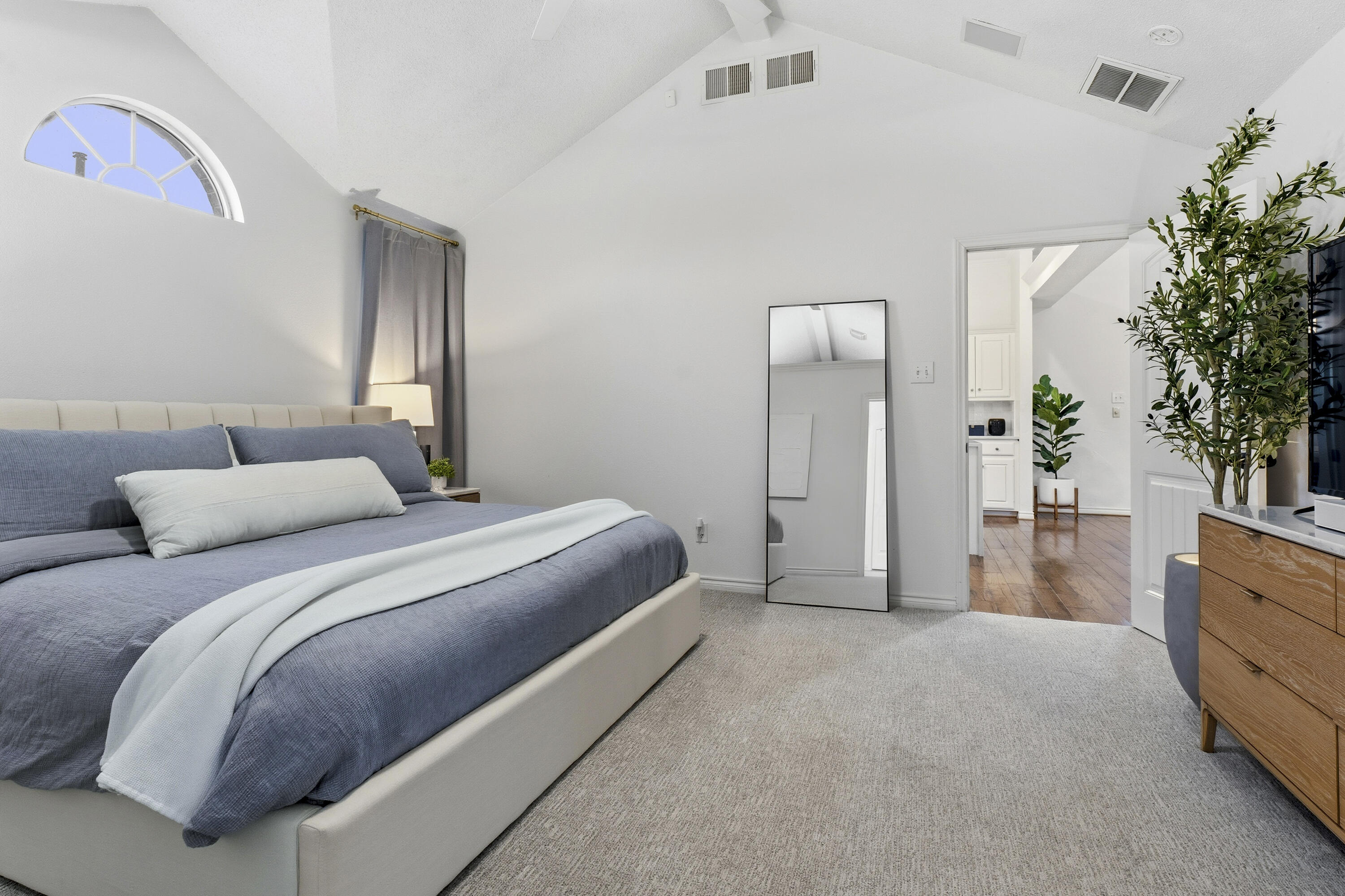 5830 101st Street Lubbock, TX 79424 - Photo 13 of 26 a bedroom with a bed and a potted plant