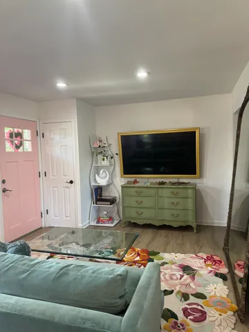 a living room with furniture and a flat screen tv