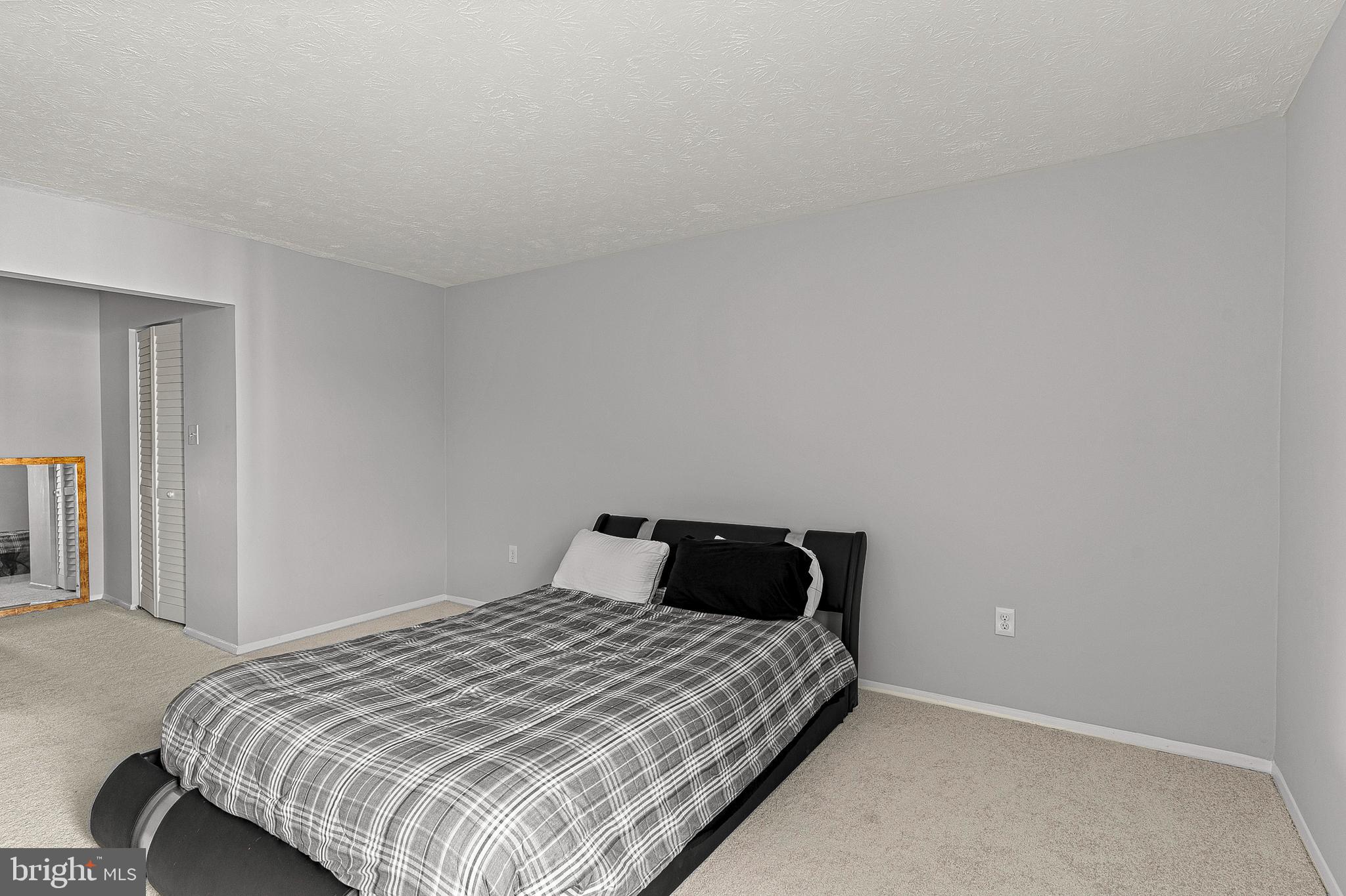 8005 Mandan Road, Unit 302 Greenbelt, MD 20770 - Photo 16 of 22 a bedroom with a bed and a window