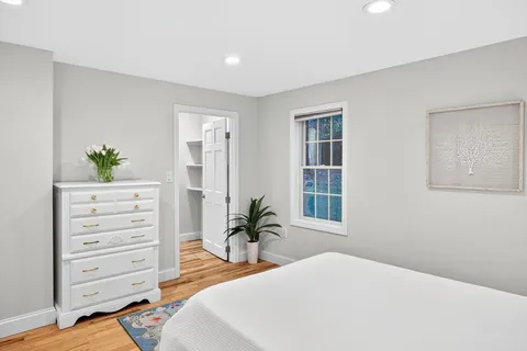 a bedroom with a bed and a dresser