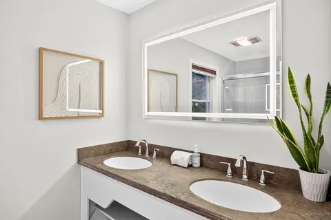 a bathroom with a sink a mirror and a toilet