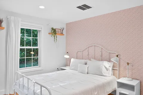 a bedroom with a bed and a night stand