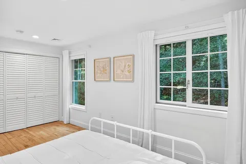 a bedroom with a bed and window