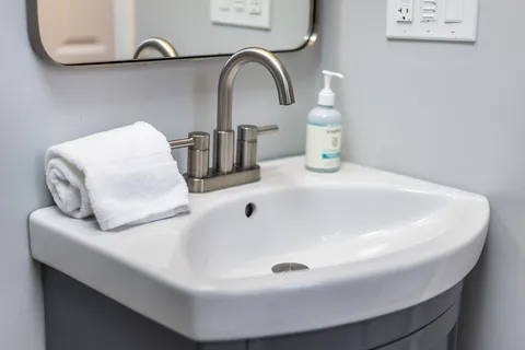 a view of a two chairs in the deck next to a yard