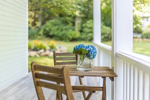 a view of backyard with a garden and deck