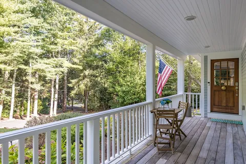 a view of two chairs in a balcony
