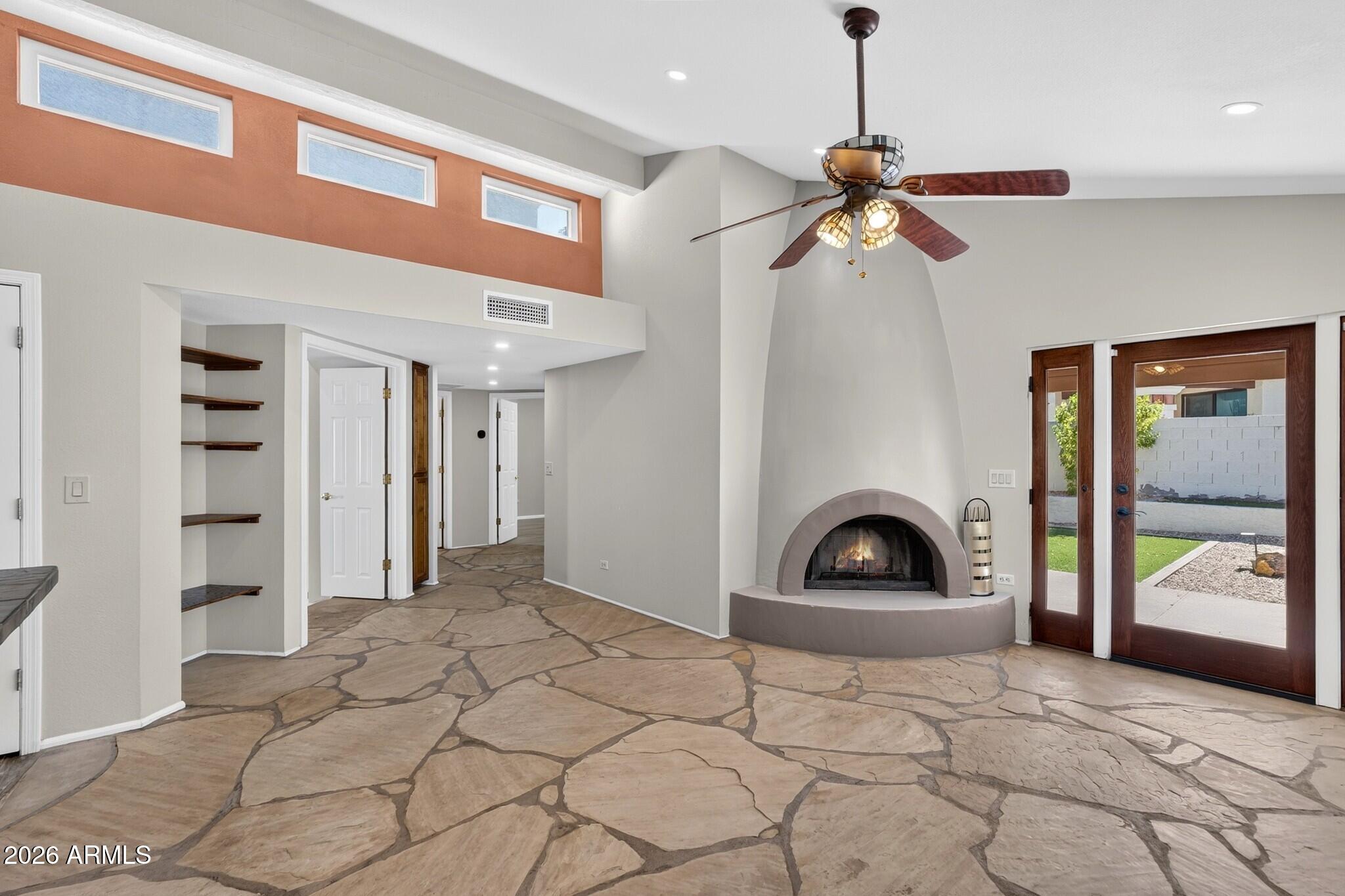 4615 East Monte Way Phoenix, AZ 85044 - Photo 6 of 35 a view of a livingroom with a staircase and a ceiling fan