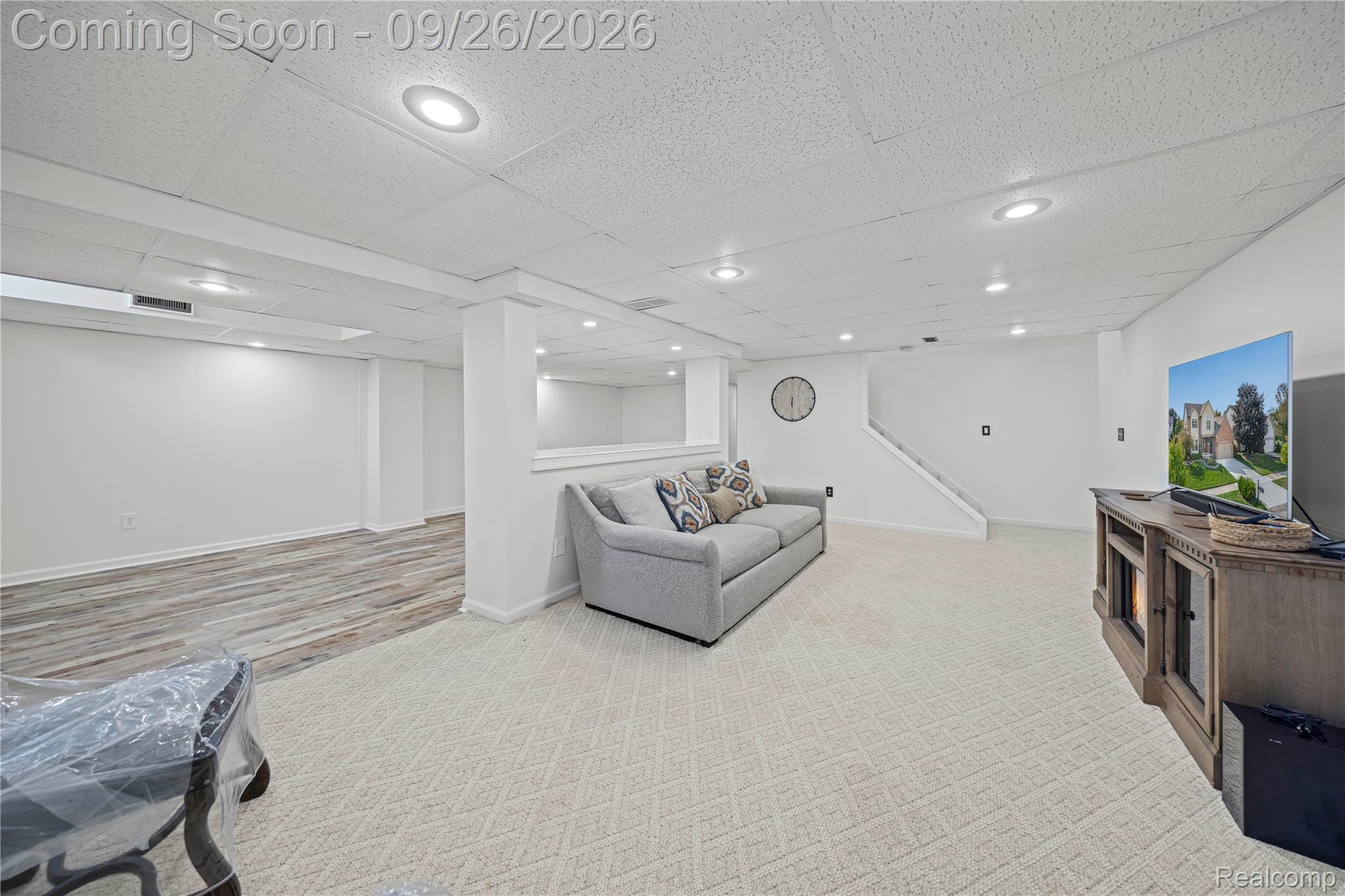 7021 Fox Path Canton, MI 48187 - Photo 5 of 59 Open-concept living space featuring recessed lighting, carpeting, wood-finish flooring, and a white staircase