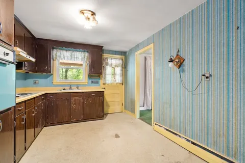 a spacious bathroom with a double vanity sink a mirror and a shower