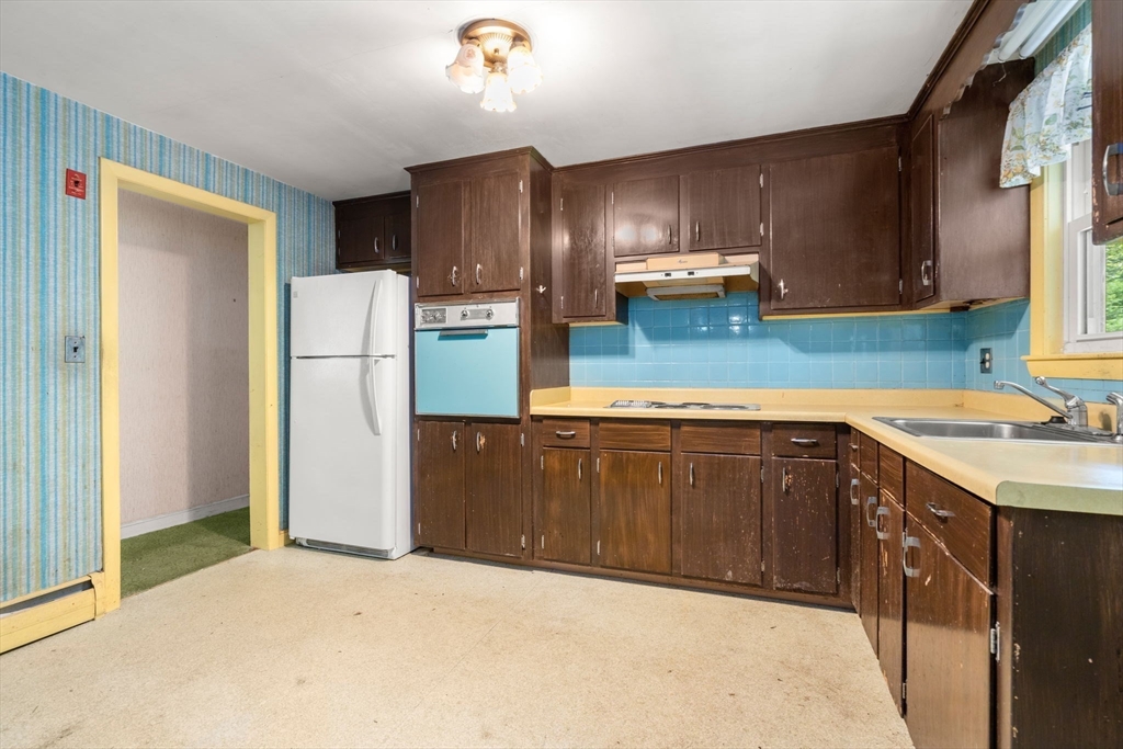 37 Freemont Street Lexington, MA 02421 - Photo 17 of 21 a kitchen with a sink a refrigerator and a stove top oven