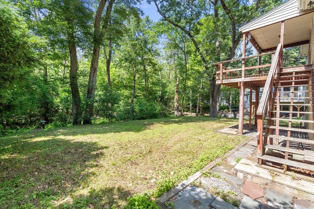 37 Freemont Street Lexington, MA 02421 - Photo 6 of 21 a backyard of a house with large trees and plants