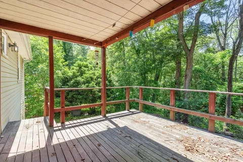 a view of a balcony with wooden floor
