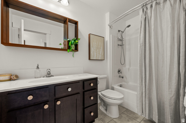 14728 South Canyon Pointe Road Draper, UT 84020 - Photo 25 of 35 Bathroom featuring a dark wood-finish vanity with a white countertop and integrated sink, a large wood-framed mirror, a white toilet, and a bathtub with an integrated showerhead