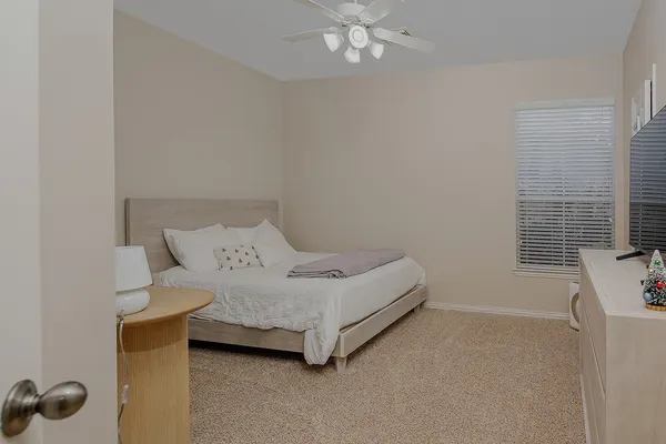 a bedroom with a bed and a window