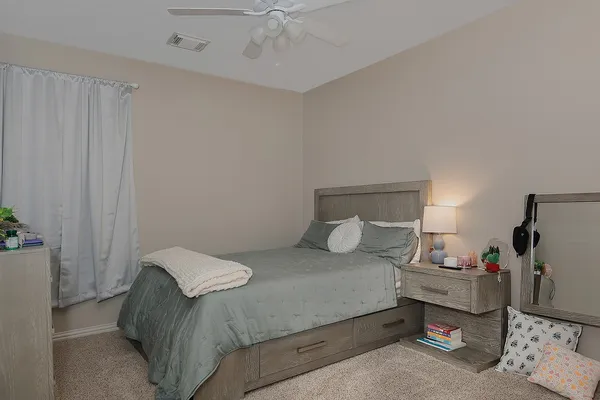 a bedroom with a bed and a window