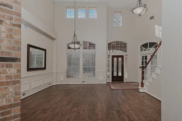 a view of an entryway with wooden floor