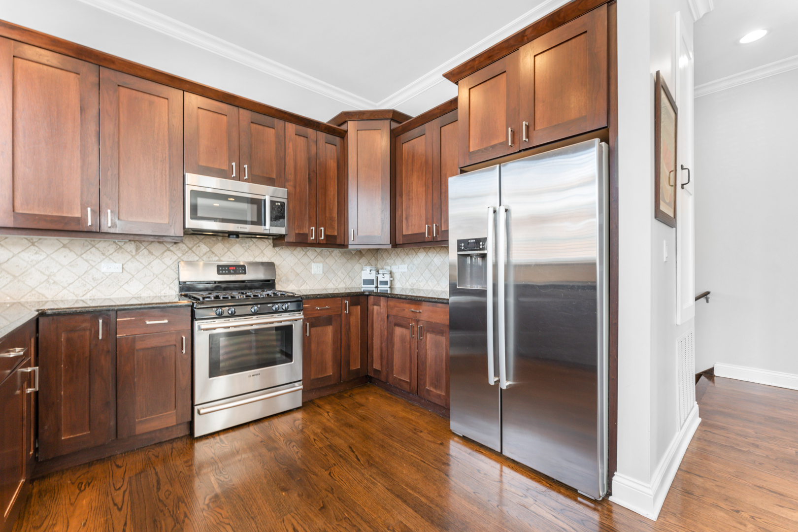2060 North Stave Street, Unit 9 Chicago, IL 60647 - Photo 13 of 31 a kitchen with stainless steel appliances granite countertop a refrigerator a sink and a stove