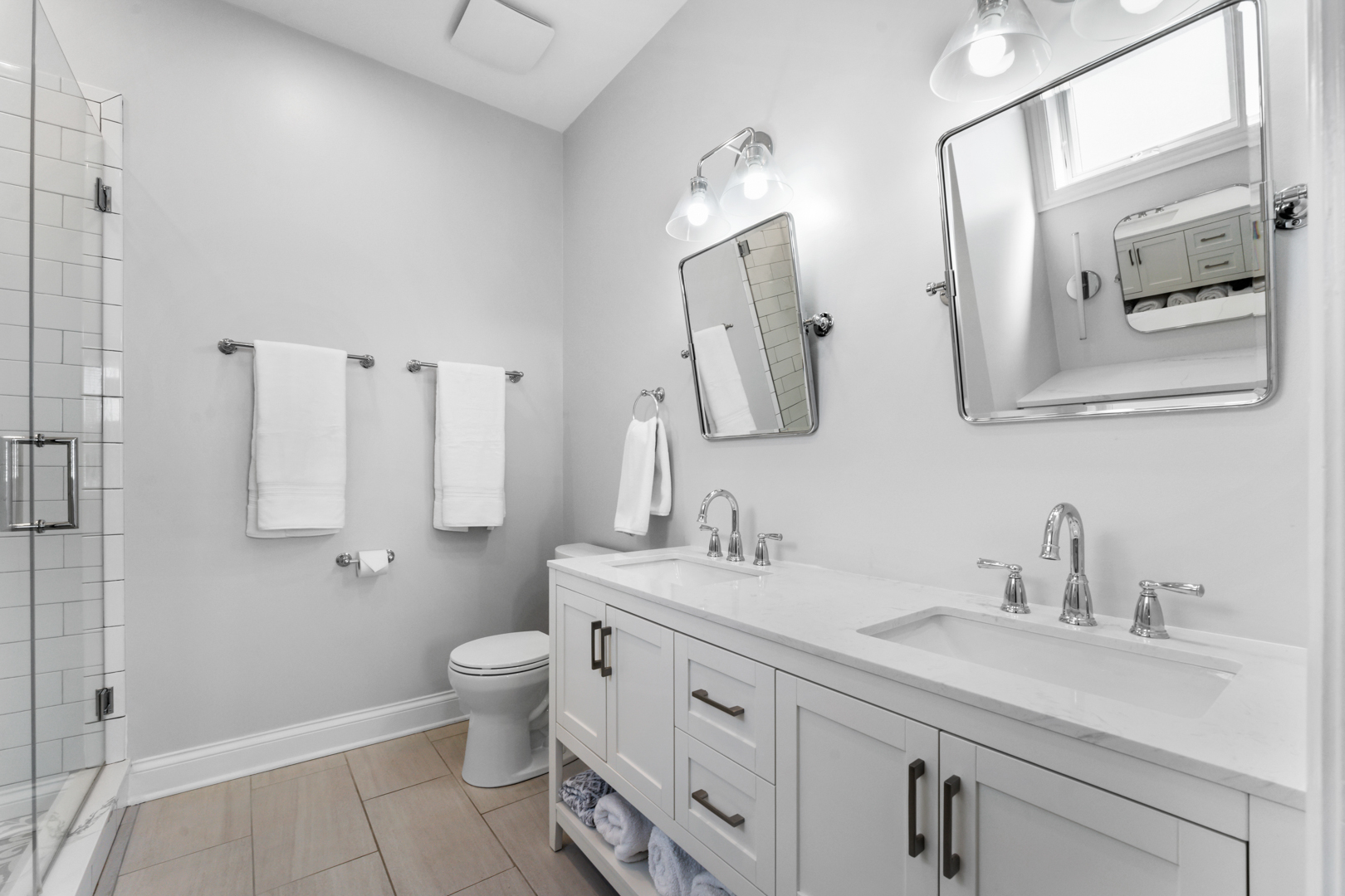 2060 North Stave Street, Unit 9 Chicago, IL 60647 - Photo 16 of 31 a bathroom with double vanity sink a mirror and a toilet