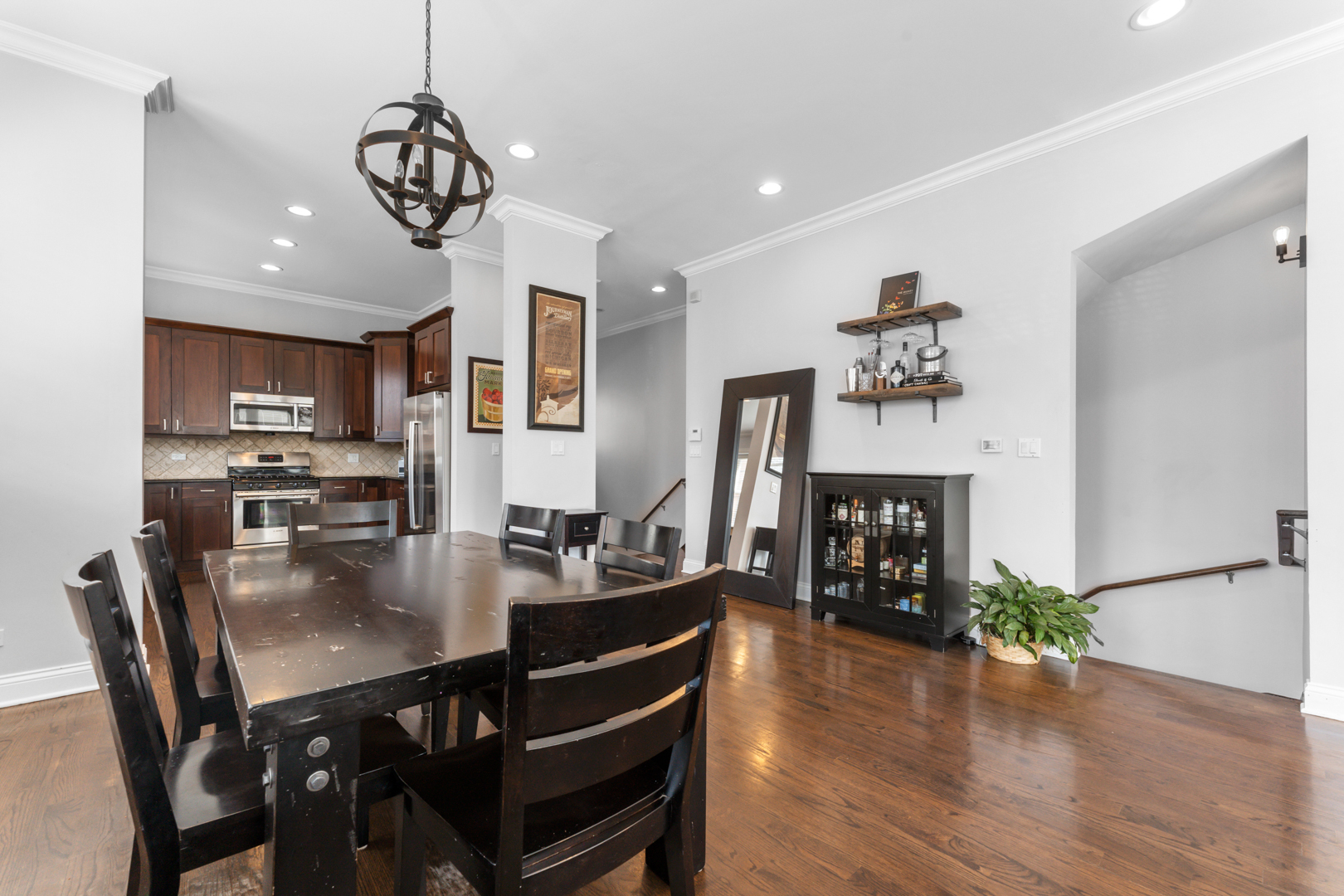 2060 North Stave Street, Unit 9 Chicago, IL 60647 - Photo 10 of 31 a view of a dining room and livingroom with furniture wooden floor a chandelier
