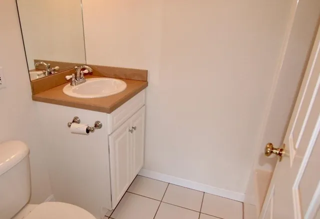 a bathroom with a sink and mirror with toilet