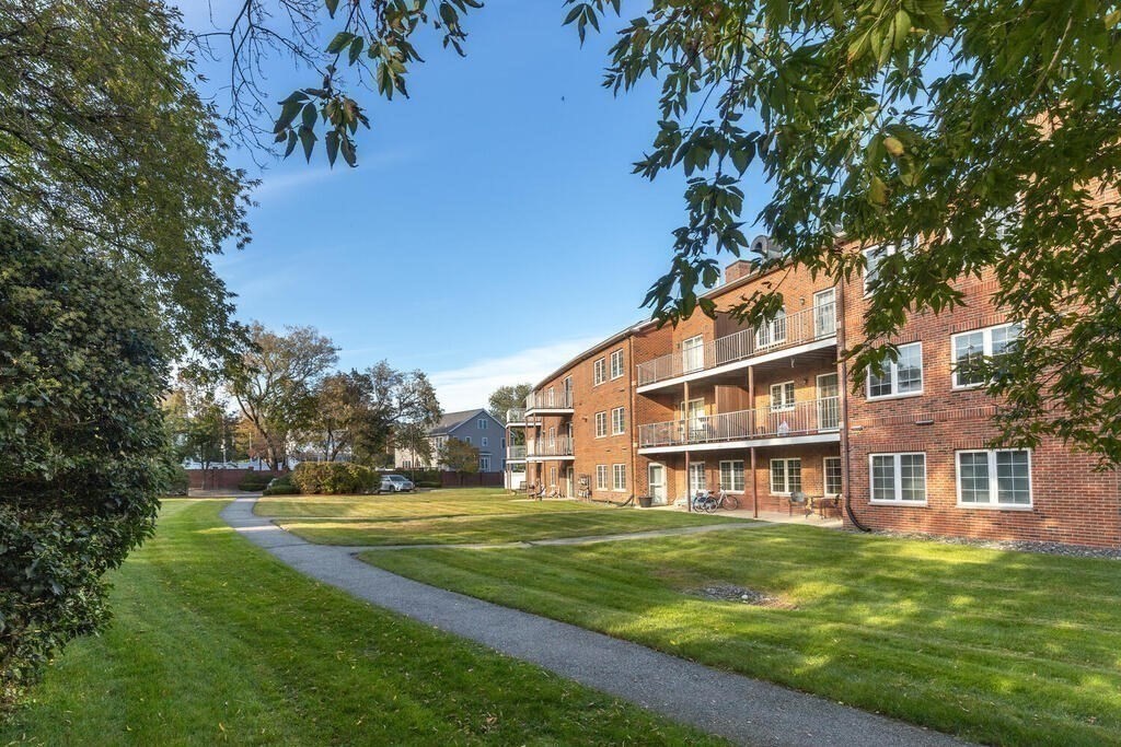 7 Conant Road, Unit 67 Winchester, MA 01890 - Photo 18 of 26 a view of a big yard with large tree and plants
