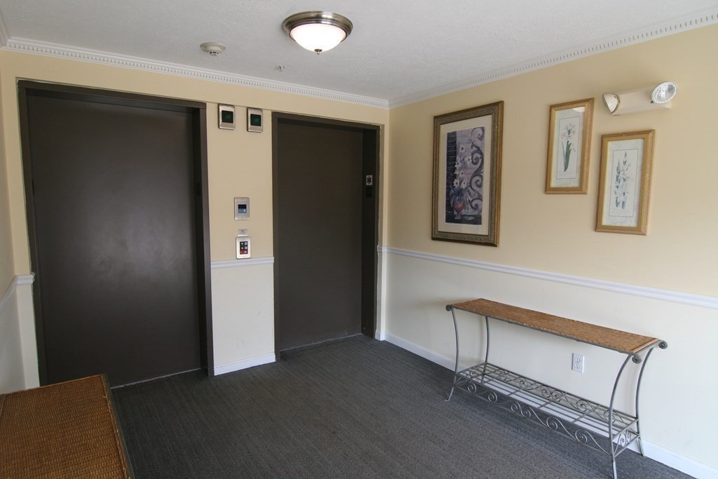 7 Conant Road, Unit 67 Winchester, MA 01890 - Photo 19 of 26 a view of a hallway with closet area