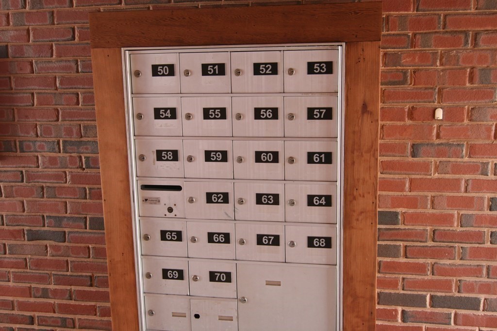 7 Conant Road, Unit 67 Winchester, MA 01890 - Photo 22 of 26 a view of a wooden door and brick wall