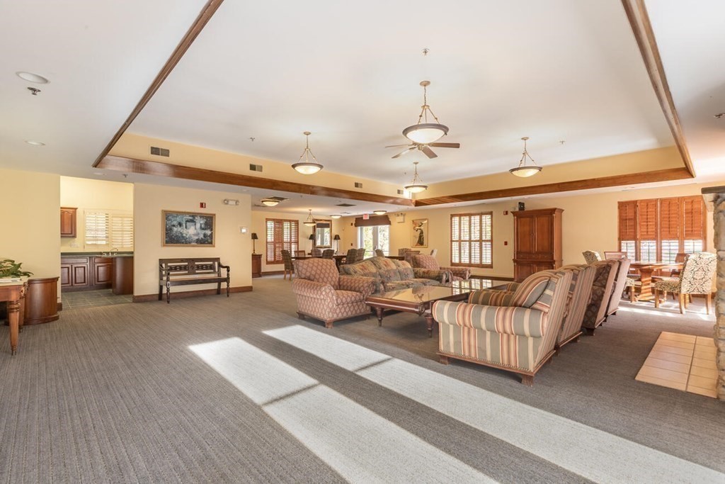 7 Conant Road, Unit 67 Winchester, MA 01890 - Photo 26 of 26 a living room with furniture and a chandelier