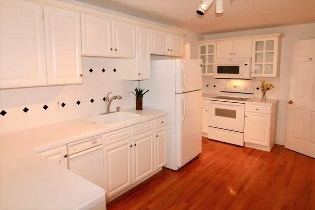 a kitchen with stainless steel appliances a refrigerator sink and cabinets