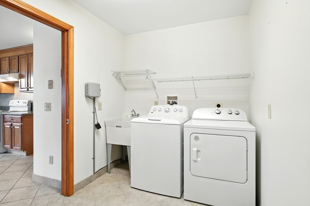 254 Island Pond Road Springfield, MA 01118 - Photo 12 of 26 a utility room with dryer and washer