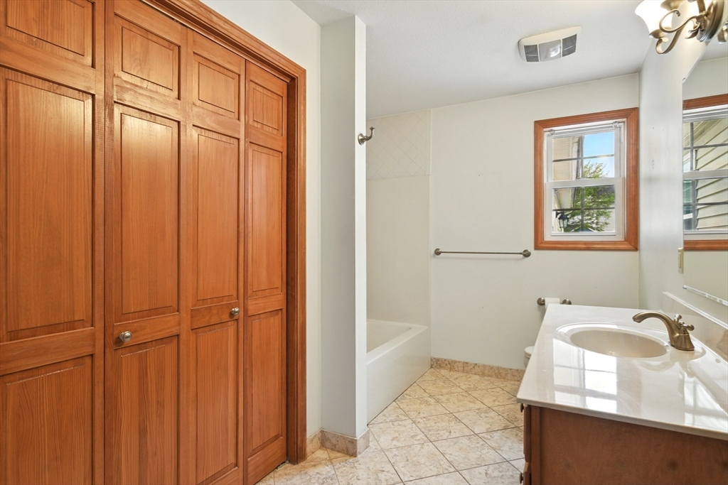 254 Island Pond Road Springfield, MA 01118 - Photo 13 of 26 a bathroom with a granite countertop sink and a mirror