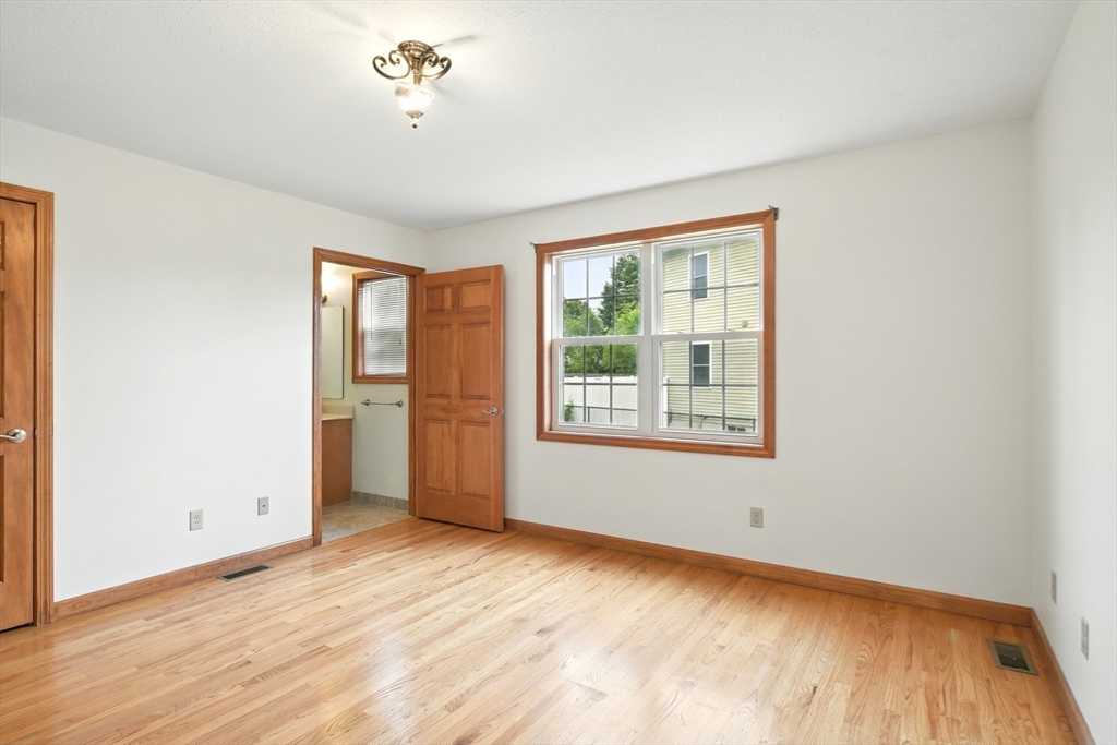 254 Island Pond Road Springfield, MA 01118 - Photo 15 of 26 a view of an empty room with a window