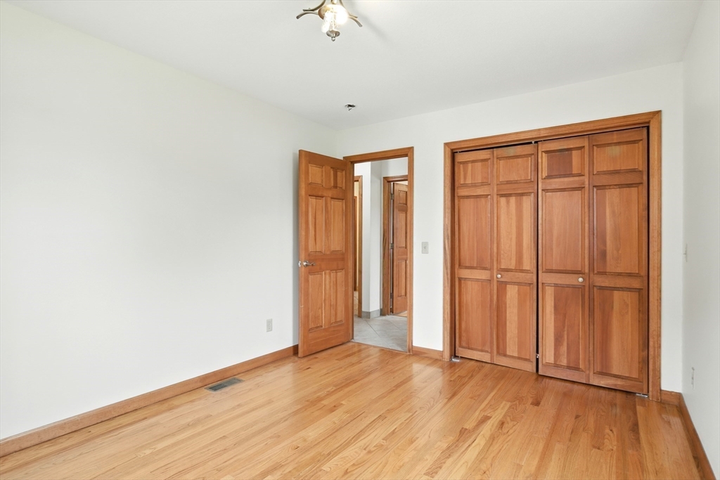 254 Island Pond Road Springfield, MA 01118 - Photo 16 of 26 an empty room with wooden floor