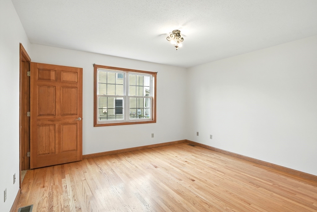 254 Island Pond Road Springfield, MA 01118 - Photo 17 of 26 wooden floor in an empty room with a window