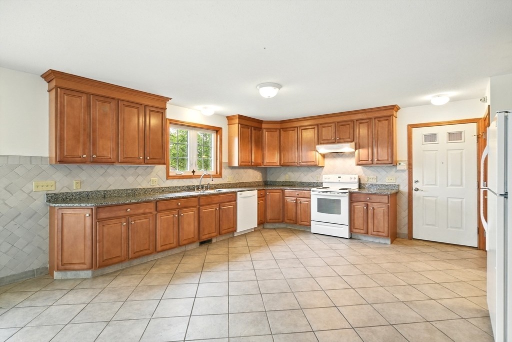 254 Island Pond Road Springfield, MA 01118 - Photo 7 of 26 a large kitchen with a stove a sink dishwasher and a refrigerator