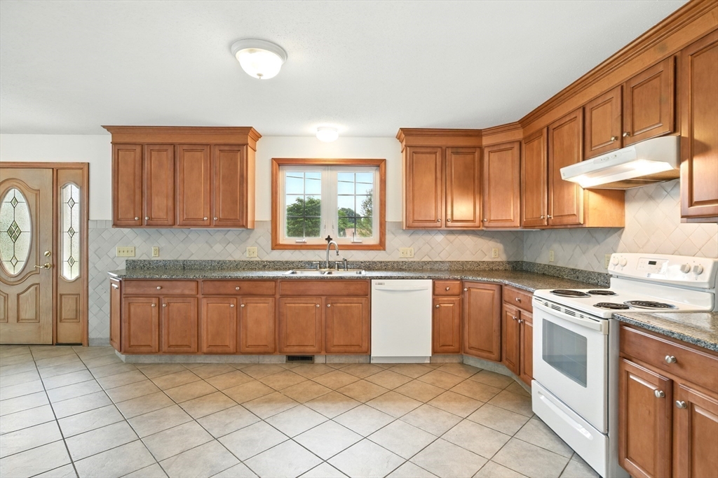 254 Island Pond Road Springfield, MA 01118 - Photo 8 of 26 a kitchen with stainless steel appliances granite countertop a stove a sink and a refrigerator