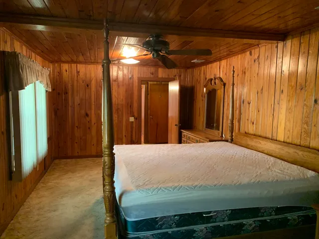 a bed room with a bed and a large window