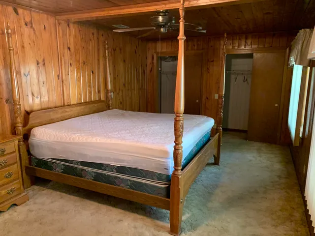 a bedroom with a bed and a mirror