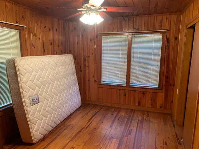 a view of a room with wooden floor and staircase