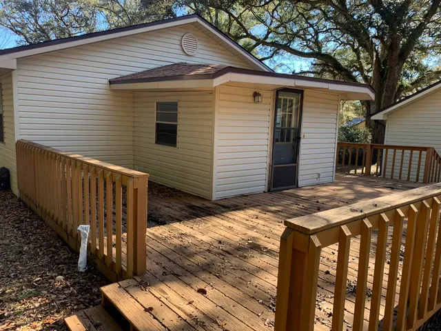 a view of a house with wooden fence